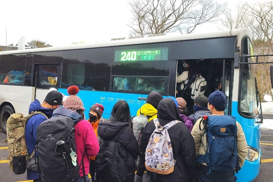 People crowding onto the 240 bus after hiking Hallasan in winter