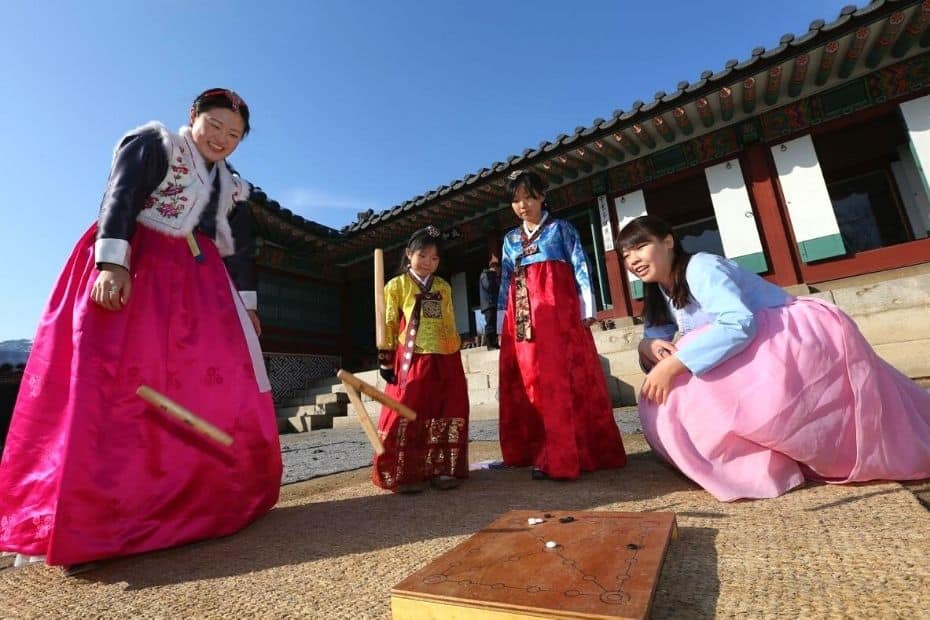 Korean family playing yut nori during a Korean holiday
