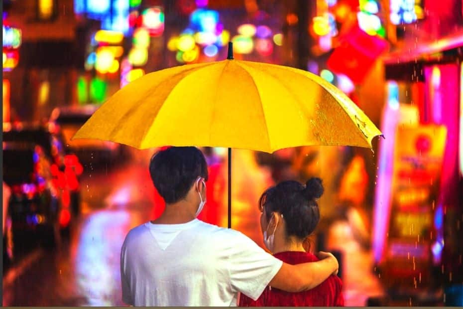 Korean couple walking together in the rain